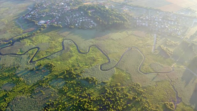 4k drone forward video (Ultra High Definition) of flooded valley. Misty morning scene of snake shape Seret river. Wonderful summer view of Ternopil countryside, Ukraine, Europe.