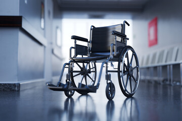 Unoccupied Black Wheelchair Positioned in a Bright Hospital Hallway - 767150979
