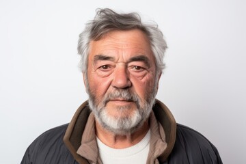 Portrait of a senior man with grey hair and beard on a white background