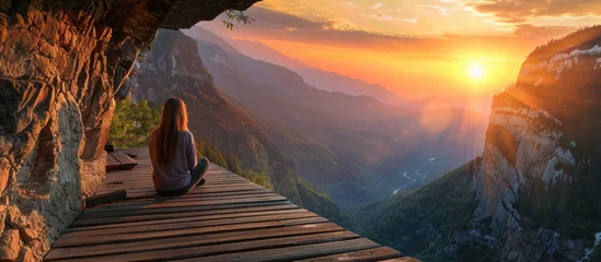 Foto op Canvas Woman admiring sunset from mountain hut © Mik Saar