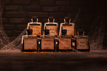 Enigmatic Vintage Potion Bottles on Moody Background with Cobwebs