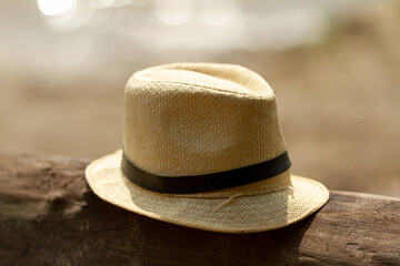 A straw hat on an old log