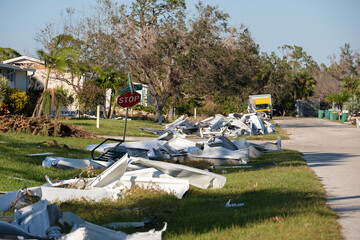 Metallic scrap rubbish on roadside from hurricane severely damaged houses in Florida residential...