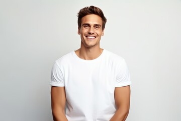 Handsome young man in white t-shirt. Studio shot.