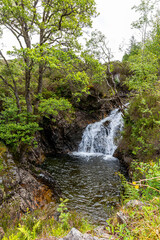 Beautiful mountain landscape in Scotland UK on a sunny May day. Waterfall