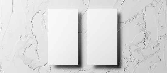 Two vertical business cards mockups on a white textured paper background.