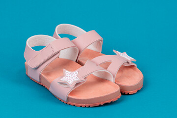 Two pink sandals on blue background. Cute pink sandals for little girl. - 767169754