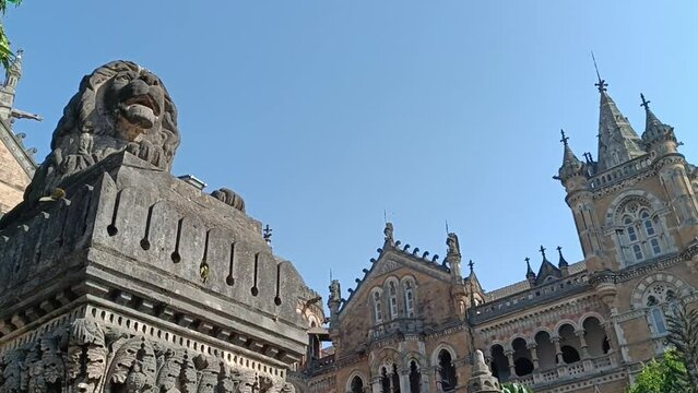 Victoria Station in Mumbai on a clear day. Mumbai, Maharashtra, India - January 24th 2020 - Wide Angle shot of vehicle traffic outside Chhatrapati Shivaji Terminus (CST), a UNESCO World Heritage Site 