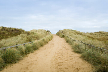 Path in sand dunes and grass on beach, Horsey Gap, Norfolk, UK