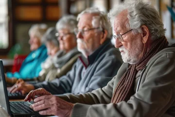 Fotobehang Group of elderly people attending an online course, taking notes on laptops in a community center © Shutter2U