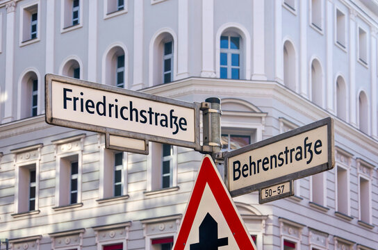 Berlin, Germany, March 8, 2024: streetname signs at the junction of Friedrichstrasse and Behrenstrasse in Mitte district