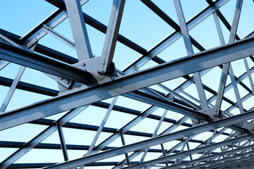Innovative Geometric Steel Framework Captured Against a Vibrant Blue Sky