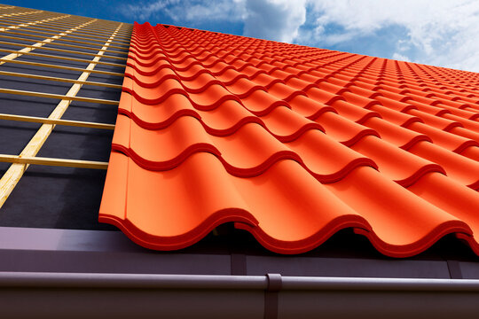 Vibrant Orange Terracotta Tiled Roof Against a Clear Blue Sky: Arresting View