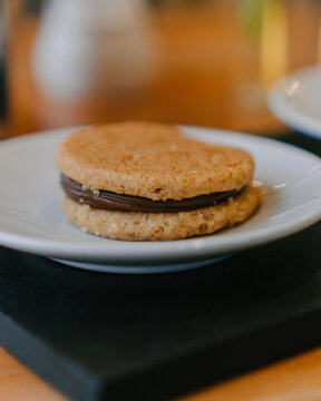 Fresh baked chocolate stuffed cookie from delicate coffee shop  over wood table
