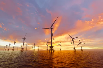 Foto op Plexiglas Majestic Offshore Wind Turbines Aglow with Vibrant Sunset Hues Over Ocean © Dabarti