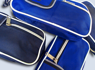 pile of black and blue bags on a white background. purse or small drawstring bag with buttons