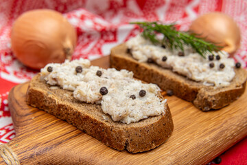 Bacon pate on black bread. Garlic salted lard. Two sandwiches closeup