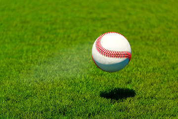 Mesmerizing Levitation of a Baseball on a Lush Green Field Under a Clear Sky