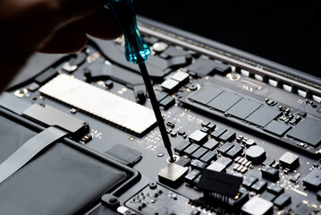 close up of Technician repairing electronic circuit board, repairing, upgrade and technology.	
