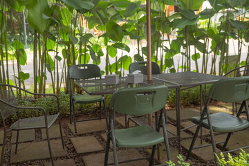 Empty chair and table on the garden cafe. The photo is suitable to use travel destination, holiday and vacation content media.