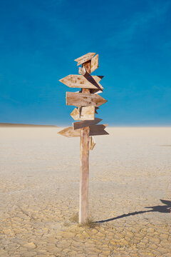 Weathered Wooden Directional Arrows Standing at a Desert Crossroads