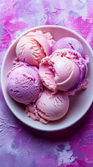 Fototapeta na wymiar A white bowl filled with ice cream in pink and purple