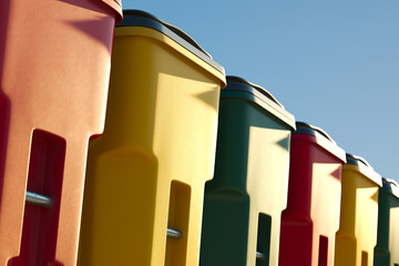 Vibrant Recycling Bins Under Clear Blue Sky - Environmental Conservation