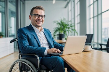 Disabled European businessman in a suit and wheelchair, smiling and working with a laptop in a modern office - obrazy, fototapety, plakaty