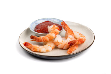 A plate of large cooked peeled shrimp with seafood sauce isolated on white