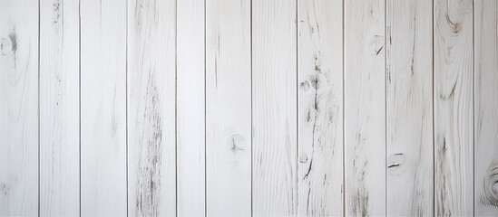 An upclose shot of a rectangular plank of hardwood flooring with a wood stain in tints and shades, creating a parallel pattern on a white wooden wall