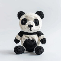 A panda toy doll made of crochet yarn.