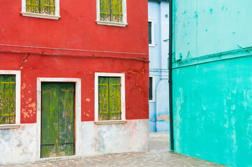 Colorful architecture in Burano island, Venice, Italy. Red and blue painted houses