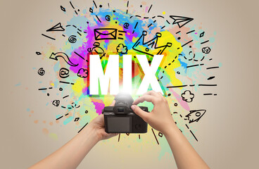 Close-up of a hand holding digital camera with abstract drawing