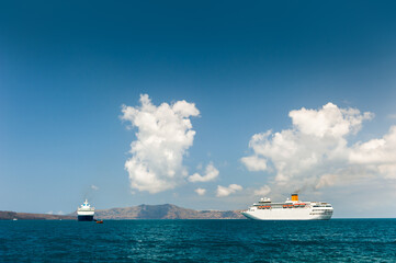 Santorini island, Greece. Cruise ship near the coast. Blue sea and the blue sky.