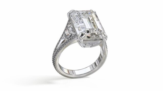 Rotating big emerald cut diamond white gold ring. During rotation, the diamond ring mockup becomes a finished product. 3d animation on white background