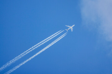 an airplane in flight in the sky on a sunny day.