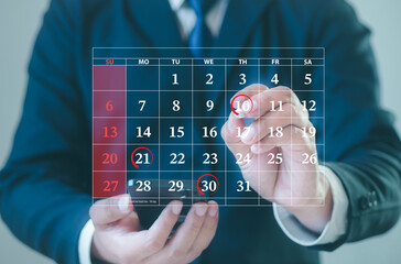 Businessman schedules meeting planning and marks red circle to Notifications via smartphone with scheduled appointments on the calendar. Schedule an activity