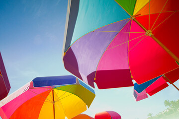 Vibrant, Multicolored Beach Umbrellas Under a Sunny Blue Sky