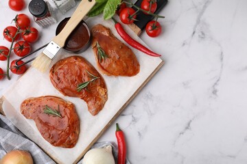 Flat lay composition with raw marinated meat, rosemary, basting brush and products on white marble...