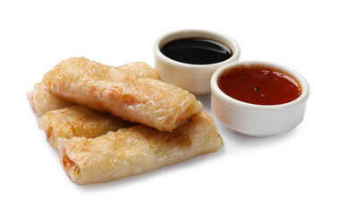 Tasty fried spring rolls and sauces isolated on white