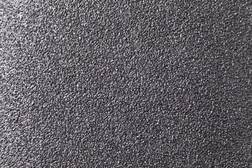 Texture of coarse sandpaper as background, top view