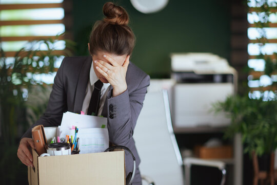 unhappy modern female employee in modern green office