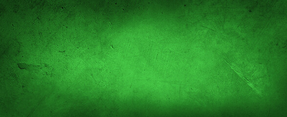 Green textured concrete wall background.Dark edges