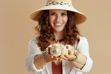 happy trendy woman in blouse and shorts on beige