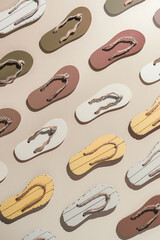 Female summer shoes, sandals as creative minimal pattern with hard shadow, beige brown white flip...