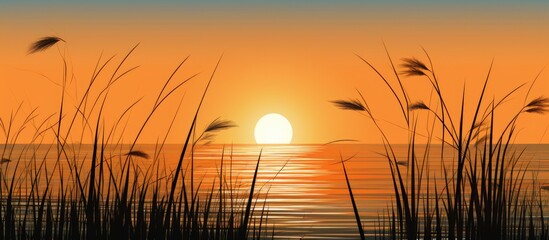 Silhouette of grass against a golden ocean sunset