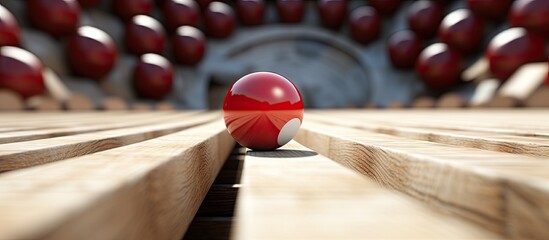 A red ball on a wooden bench in front of a building - obrazy, fototapety, plakaty
