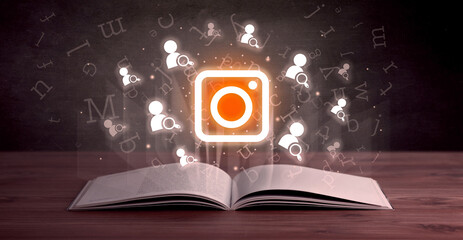 Open book with social networking icons above