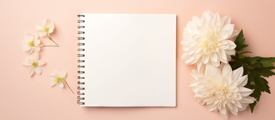 Blank notebook with white flowers on a pink background