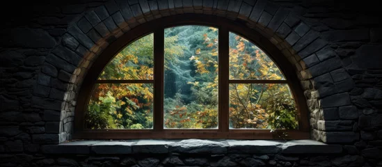 Fotobehang A window overlooking a forest outside © Ilgun